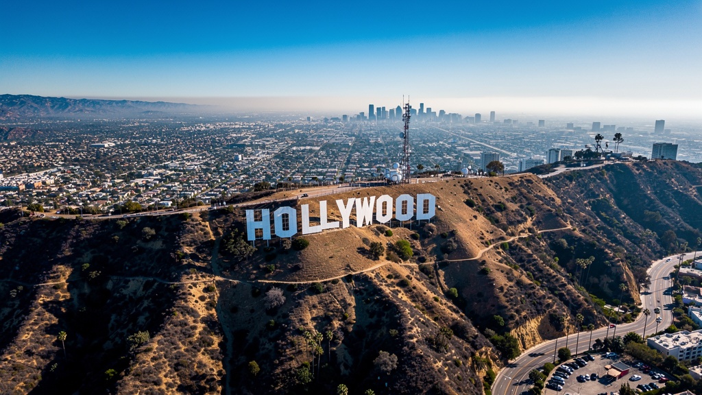 Hollywood sign on a hill with Los Angeles cityscape below